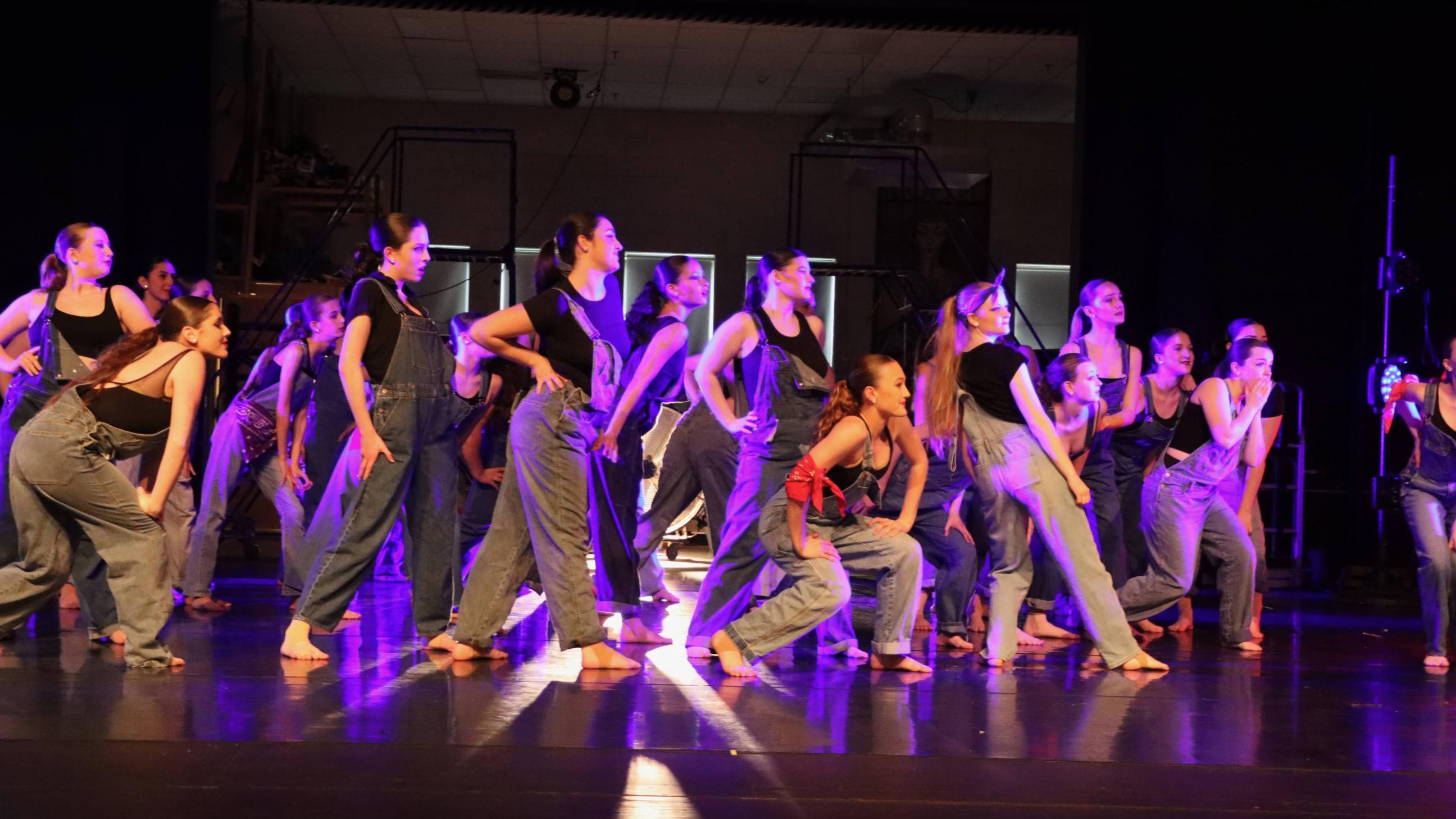 Dancers dressed in overalls 