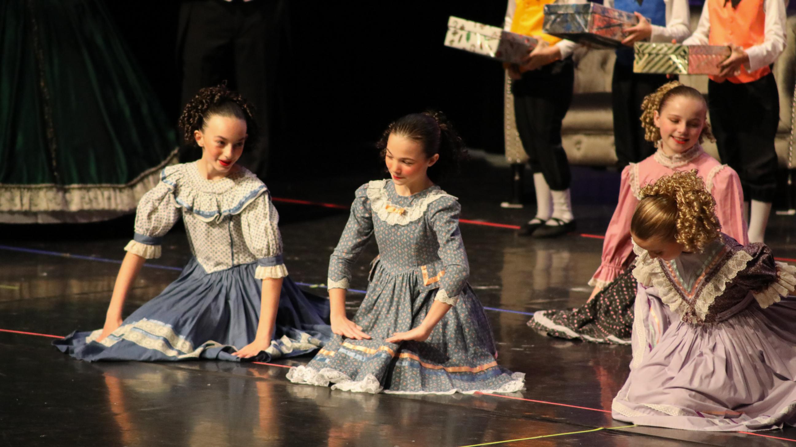 Dancers sit on the floor in party scene