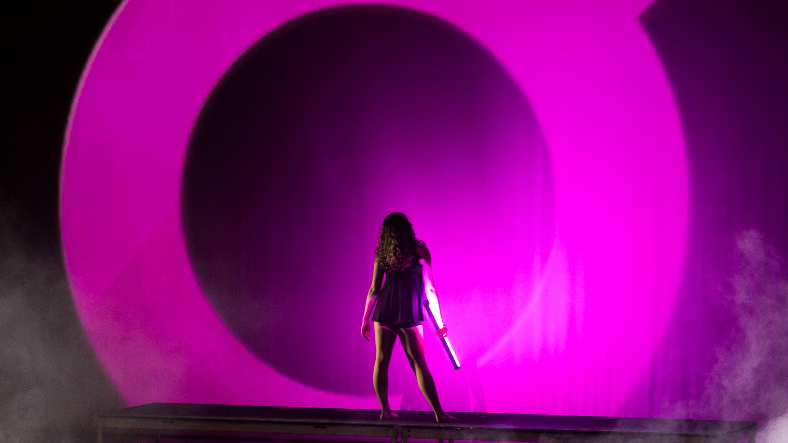 One Dancer in front of a  purple background 