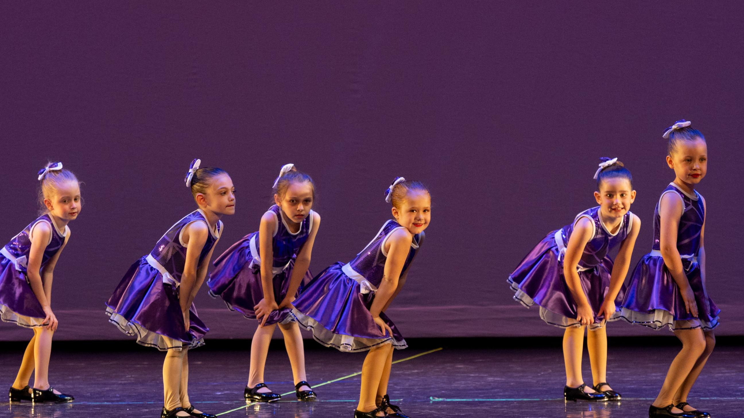 Young Tap Dancers in Purple Dresses
