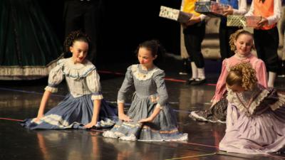 Dancers sit on the floor in party scene