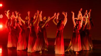 Dancers in a circle with red lighting