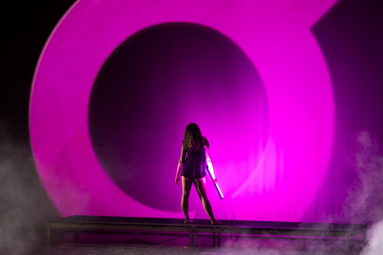 One Dancer in front of a  purple background 