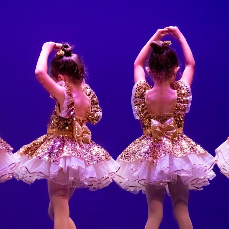 Young ballet dancers with gold sequined dresses